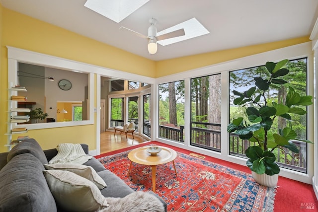 living room featuring a wealth of natural light, visible vents, and a skylight