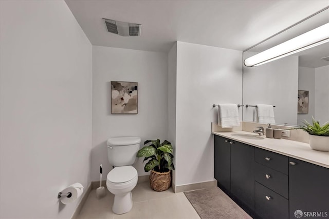 bathroom featuring tile patterned floors, vanity, and toilet