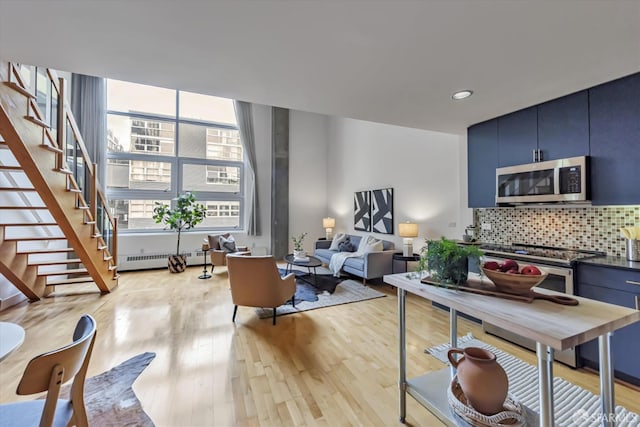 interior space featuring radiator heating unit and light wood-type flooring