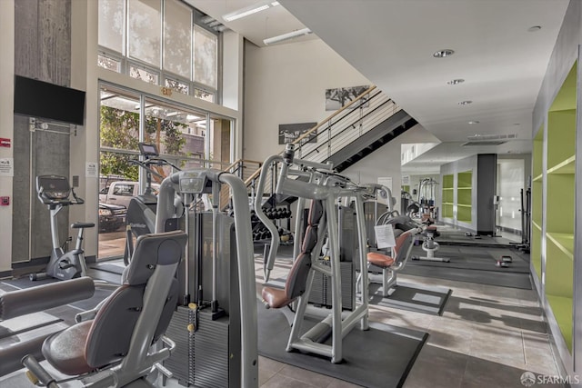 exercise room featuring a high ceiling