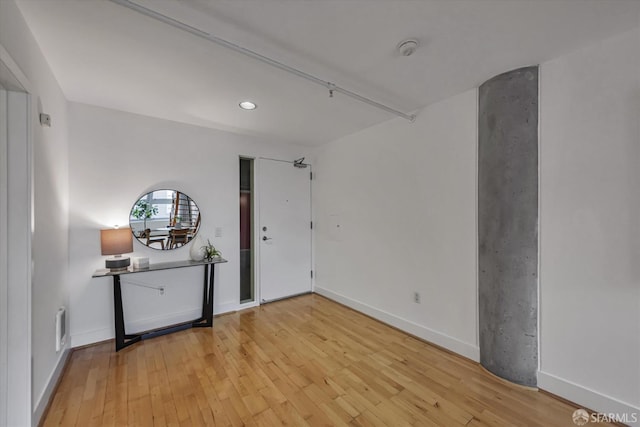 unfurnished room with hardwood / wood-style floors