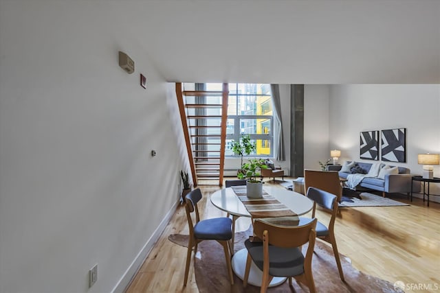 dining room featuring light hardwood / wood-style flooring and floor to ceiling windows