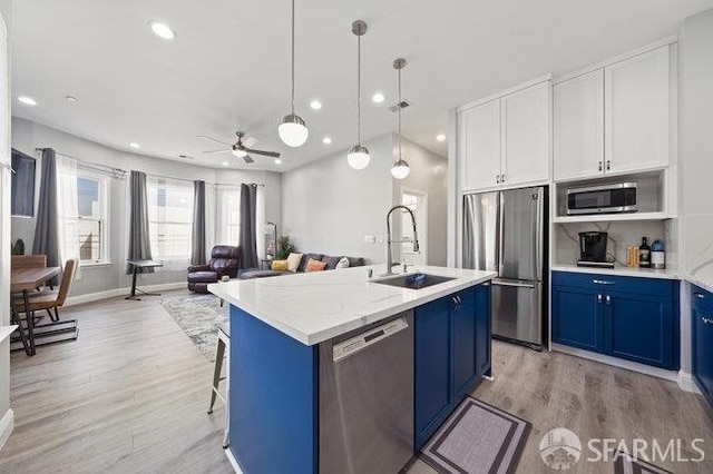 3000 26th St, San Francisco, CA 94110 - kitchen featuring stainless steel appliances, blue cabinets, recessed lighting, a sink, and light wood-style flooring