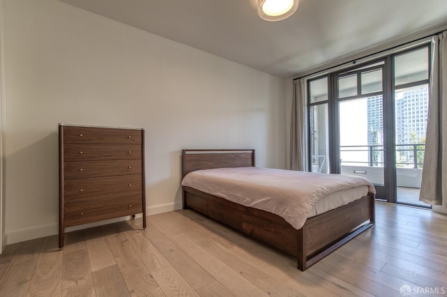 875 California St Unit 403, San Francisco, CA 94108 - bedroom with access to exterior, light wood-style floors, and baseboards