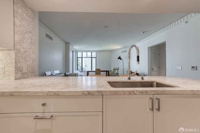 875 California St Unit 403, San Francisco, CA 94108 - kitchen with a sink, white cabinets, and open floor plan