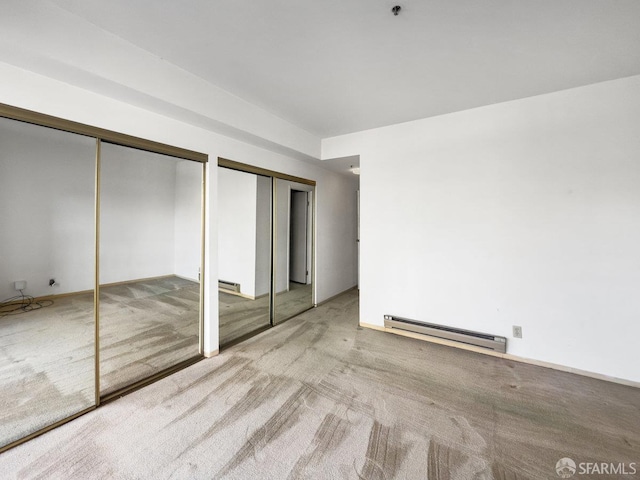 601 Van Ness Ave Unit 71, San Francisco, CA 94102 - unfurnished bedroom featuring a baseboard radiator, multiple closets, and carpet floors