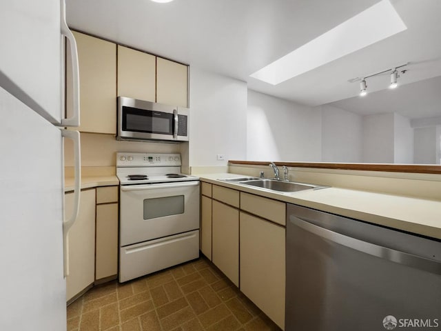 601 Van Ness Ave Unit 71, San Francisco, CA 94102 - kitchen with appliances with stainless steel finishes, cream cabinetry, light countertops, and a skylight
