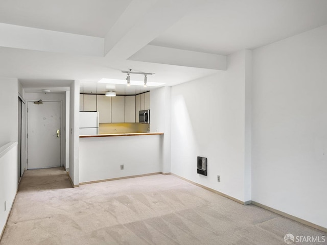 601 Van Ness Ave Unit 71, San Francisco, CA 94102 - kitchen featuring freestanding refrigerator, light carpet, stainless steel microwave, and heating unit