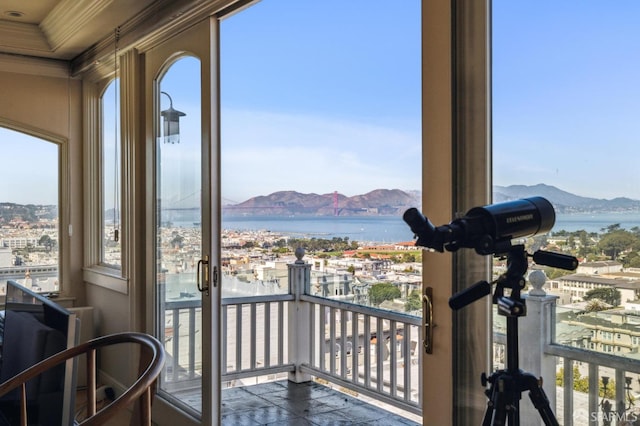 balcony featuring a water and mountain view