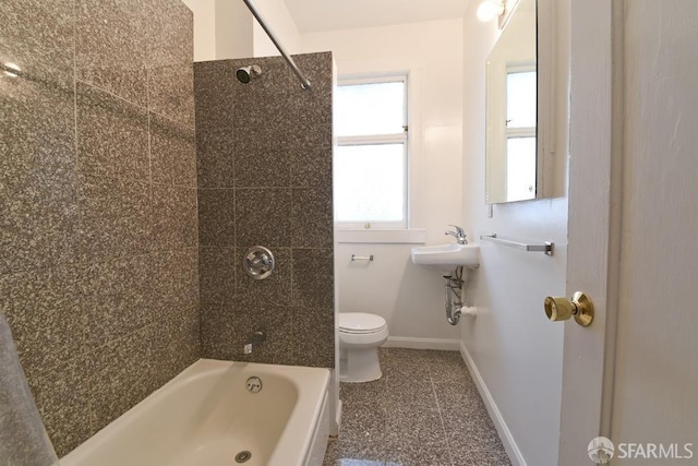 bathroom with baseboards, toilet, and shower / bathtub combination