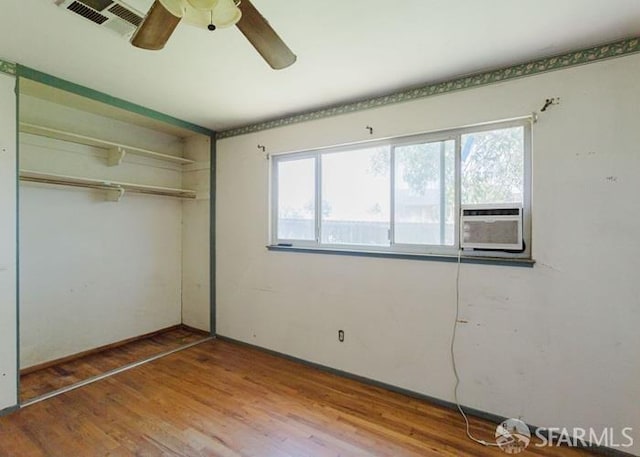 615 Wernmark Dr, Red Bluff, CA 96080 - unfurnished bedroom featuring a closet, multiple windows, wood finished floors, and ceiling fan