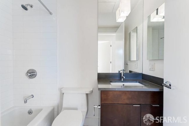 full bathroom with tiled shower / bath combo, vanity, and toilet