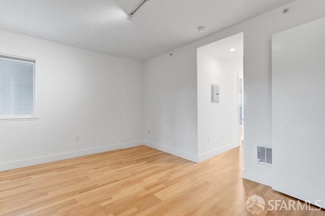 spare room featuring light hardwood / wood-style flooring