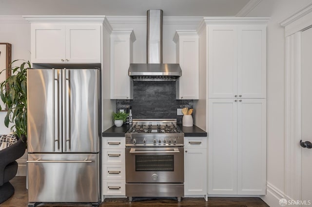 438 Broderick St, San Francisco, CA 94117 - kitchen featuring high end appliances, wall chimney exhaust hood, dark countertops, and backsplash