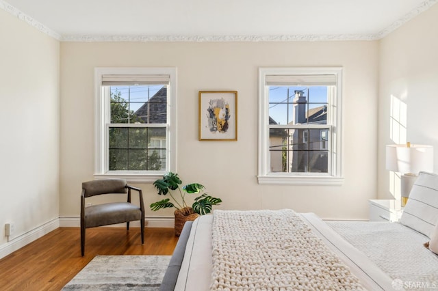 bedroom with wood-type flooring and multiple windows