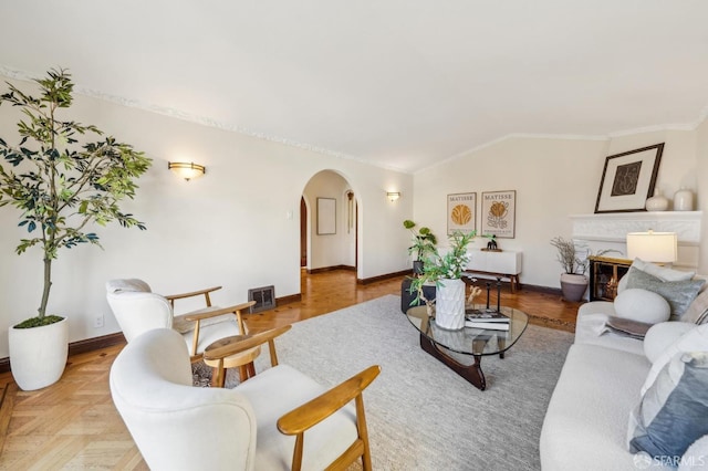 living room with crown molding, parquet flooring, and vaulted ceiling