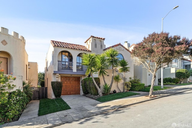 mediterranean / spanish-style house featuring a balcony and a garage