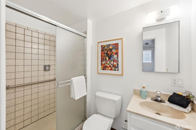 bathroom with vanity, an enclosed shower, and toilet