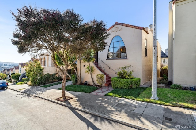 mediterranean / spanish-style home featuring a front yard