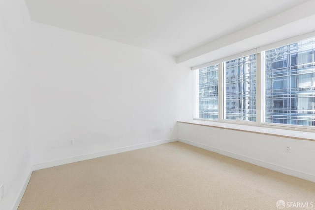 301 Mission St Unit 8E, San Francisco, CA 94105 - spare room featuring light carpet and baseboards