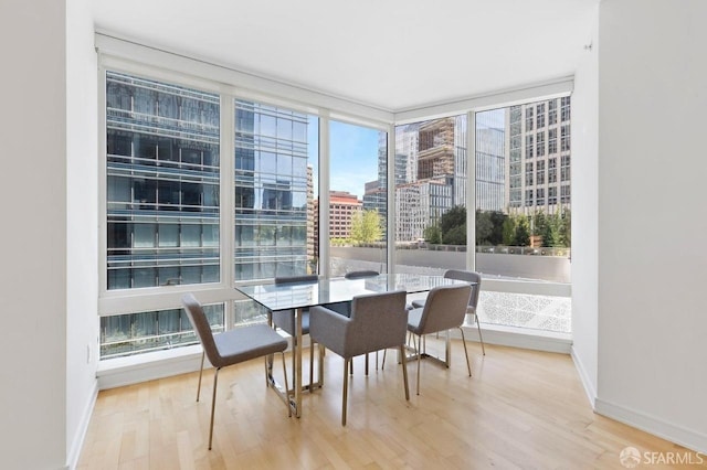 301 Mission St Unit 8E, San Francisco, CA 94105 - dining room with a city view, wood finished floors, baseboards, and expansive windows
