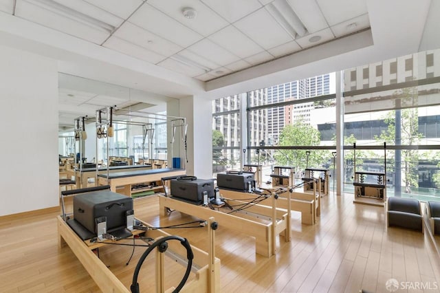 301 Mission St Unit 8E, San Francisco, CA 94105 - gym with hardwood / wood-style flooring and a wall of windows