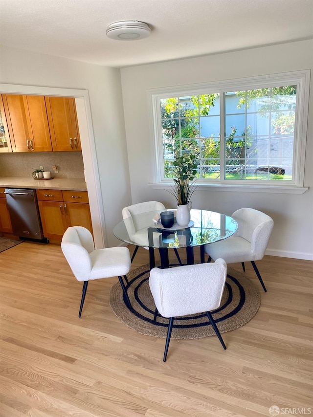 dining area featuring baseboards and light wood-style floors