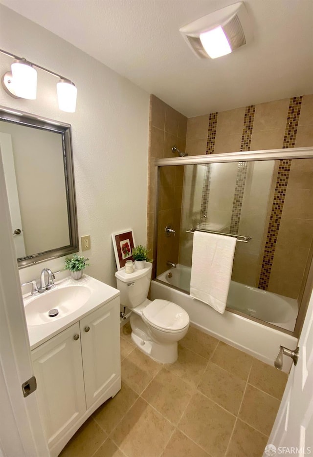 full bathroom with vanity, tile patterned floors, toilet, and shower / bath combination with glass door