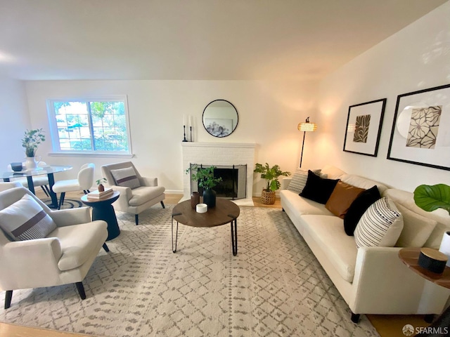 living room with a brick fireplace