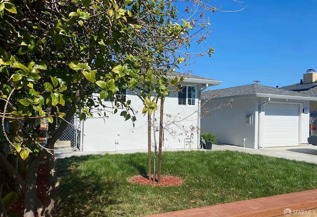 view of home's exterior with a lawn, a garage, and stucco siding