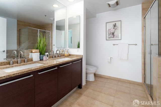 bathroom featuring vanity, toilet, and walk in shower