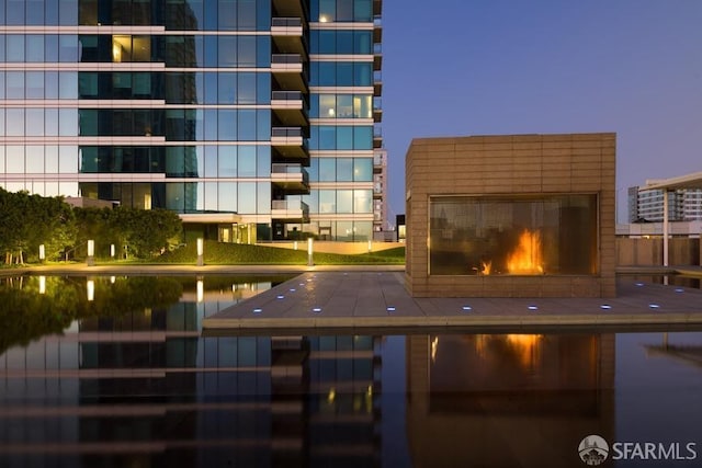 pool at dusk with a fireplace