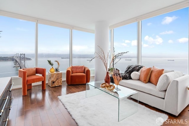 sunroom featuring a water view and a wealth of natural light