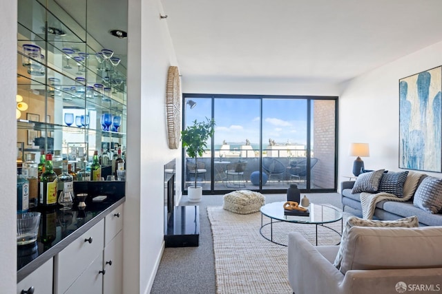 living room featuring bar area and carpet flooring