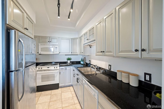 kitchen featuring light tile patterned floors, sink, white appliances, gray cabinetry, and track lighting