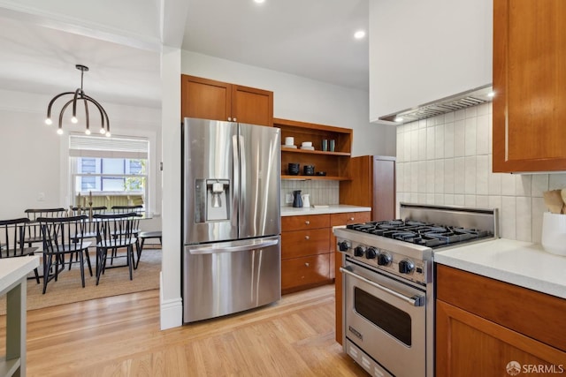 kitchen featuring light wood-type flooring, stainless steel appliances, brown cabinets, and light countertops