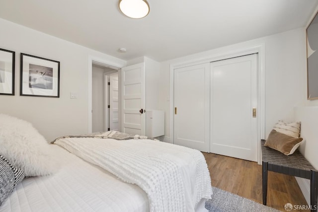 bedroom with light wood-style flooring and a closet