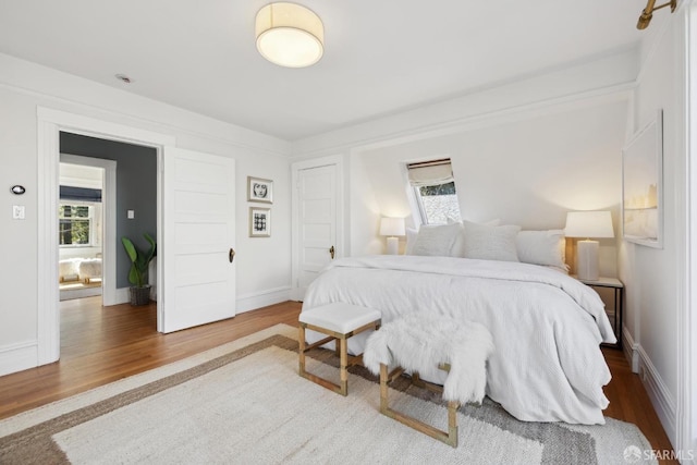 bedroom with baseboards and wood finished floors