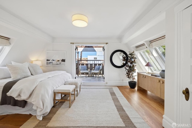 bedroom with light wood-style flooring and baseboards