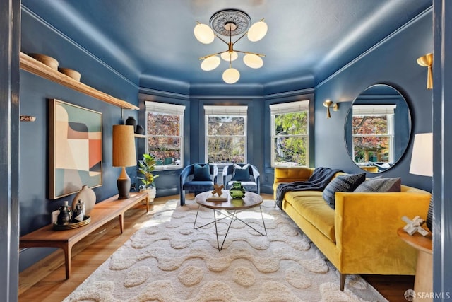 living area with a notable chandelier and wood finished floors