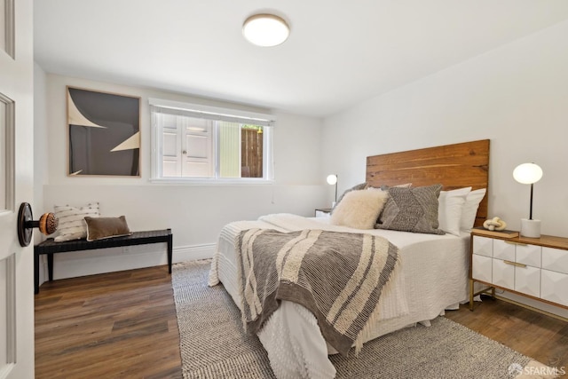 bedroom featuring wood finished floors and baseboards