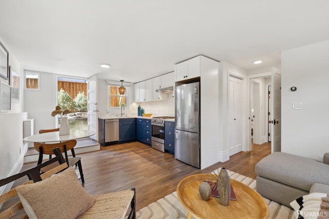 living area with recessed lighting, baseboards, and wood finished floors