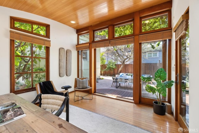 sunroom featuring wooden ceiling and plenty of natural light