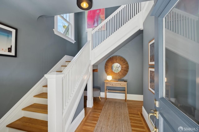 stairway featuring baseboards and wood finished floors