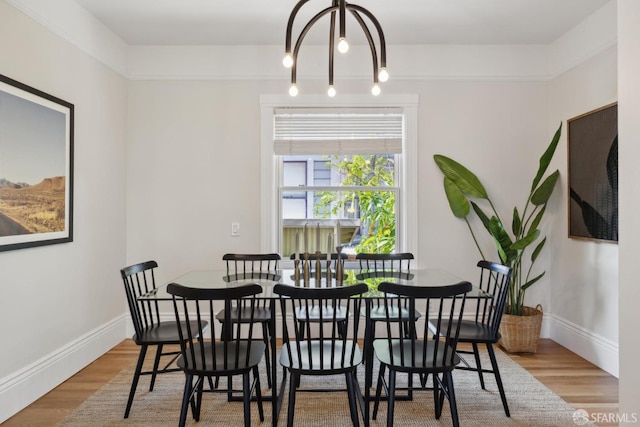 dining area with baseboards and wood finished floors