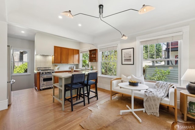 kitchen featuring open shelves, stainless steel appliances, brown cabinetry, and light countertops