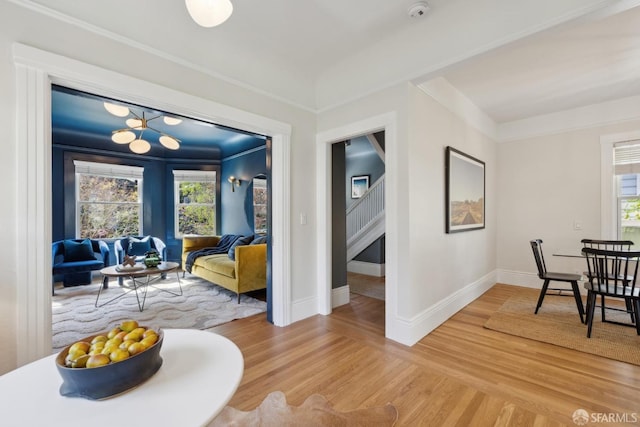 interior space with stairway, light wood-style flooring, and baseboards