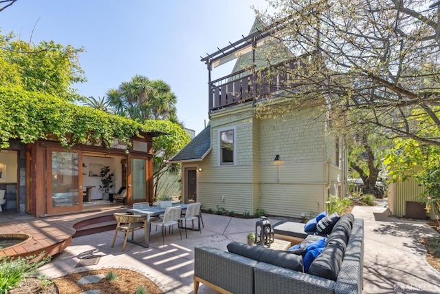 view of patio / terrace with outdoor lounge area, outdoor dining area, and a balcony