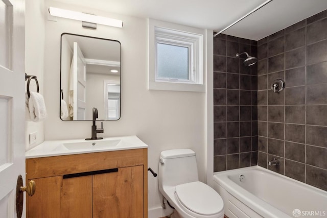 bathroom featuring vanity, bathing tub / shower combination, and toilet