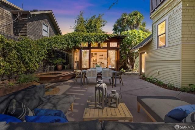 view of patio / terrace with outdoor dining area and a hot tub